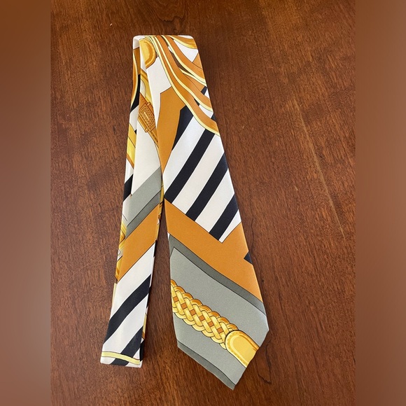 Hermes Other - Hermes Men’s tie 100% silk in gold, white, gray and black pattern.